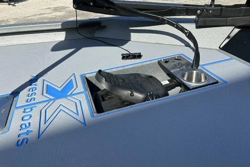 Slide: The Image of 2026 Xpress H20 Bass boat deck with control panel and cup holder. - 14