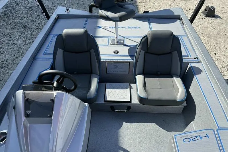 Slide: The Image of 2026 Xpress H20 Bass boat interior with dual seats and steering console. - 5