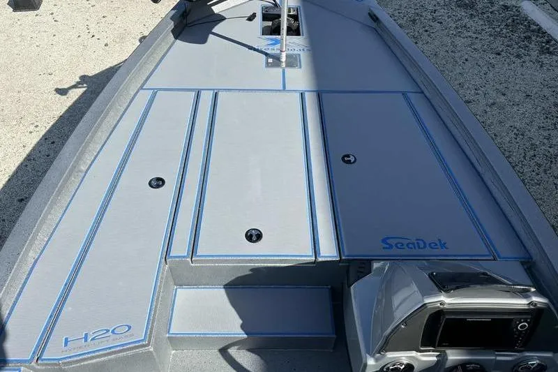 Slide: The Image of 2026 Xpress H20 Bass boat deck with SeaDek flooring, featuring sleek design and modern controls. - 6