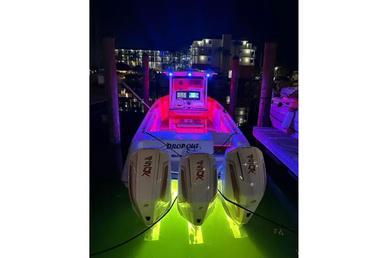 Slide: The Image of 2001 Donzi 32 VS boat with vibrant night lighting and triple 450R engines. - 5