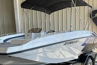 Slide: The Image of 2023 Starcraft SVX 171 OB boat with canopy in a storage facility. - 2
