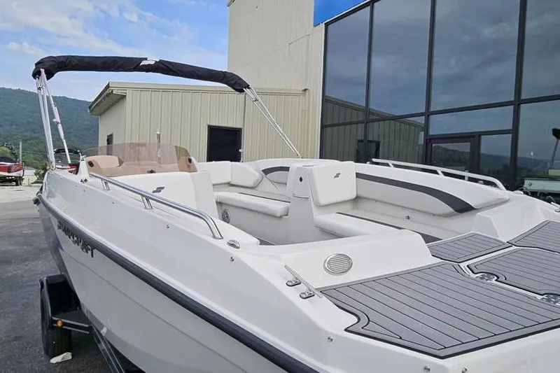 Slide: The Image of 2023 Starcraft SVX 171 OB boat with sleek design, docked near modern building. - 5