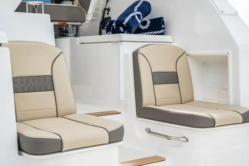 Slide: The Image of Manufacturer Provided Image: 2025 Pursuit OS 355 Offshore boat interior with beige and gray seating. - 10