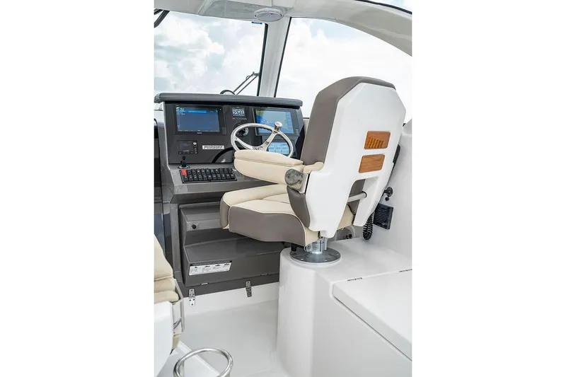 Slide: The Image of Manufacturer Provided Image: 2025 Pursuit OS 355 Offshore helm with modern controls and comfortable captain's chair. - 7