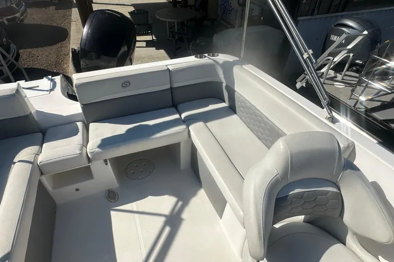 Slide: The Image of 2022 Hurricane Sundeck Sport 218 OB boat interior with gray seating and modern design. - 12