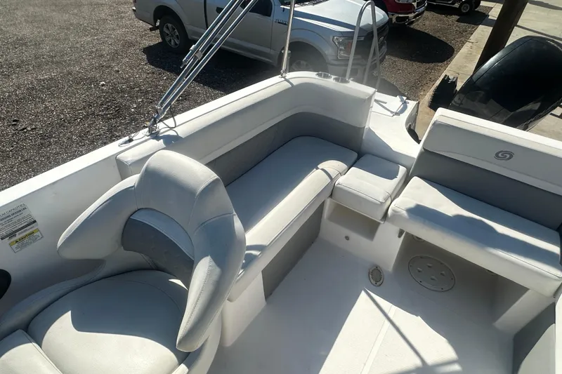 Slide: The Image of 2022 Hurricane Sundeck Sport 218 OB boat interior with seating and steering wheel. - 13