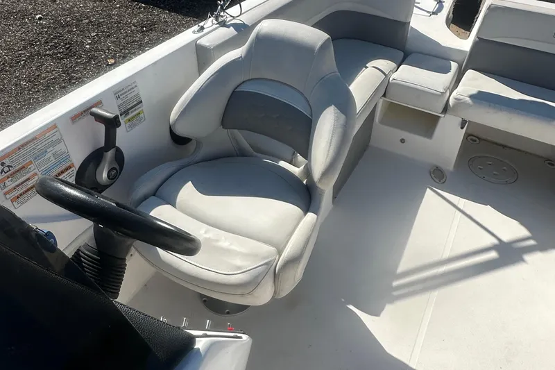 Slide: The Image of 2022 Hurricane Sundeck Sport 218 OB boat interior with steering wheel and seating. - 15