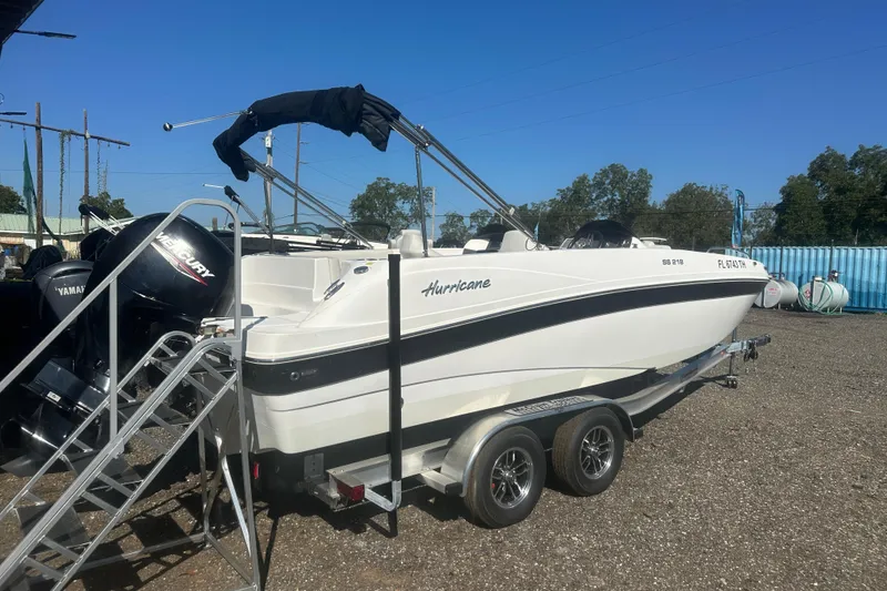 Slide: The Image of 2022 Hurricane Sundeck Sport 218 OB boat on trailer, parked outdoors. - 2