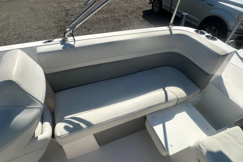 Slide: The Image of 2022 Hurricane Sundeck Sport 218 OB boat interior with white seating and cup holders. - 21