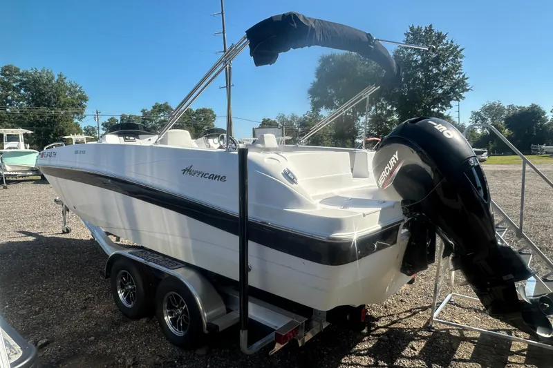 Slide: The Image of 2022 Hurricane Sundeck Sport 218 OB boat with Mercury outboard engine on trailer. - 4