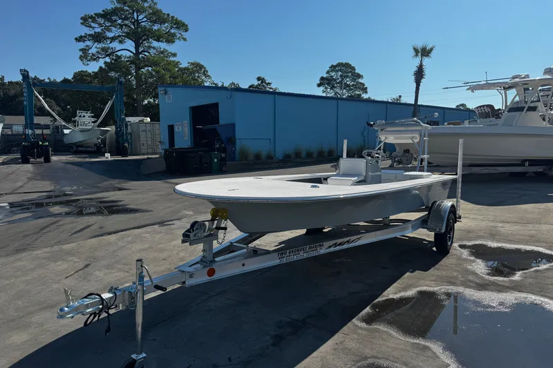 Slide: The Image of 2026 Mitzi Skiffs 17 Tournament boat on trailer in marina setting. - 10