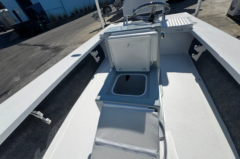 Slide: The Image of 2026 Mitzi Skiffs 17 Tournament boat interior with open storage compartment and steering wheel. - 14