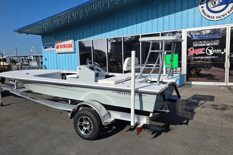 Slide: The Image of 2026 Mitzi Skiffs 17 Tournament boat on trailer outside dealership. - 3