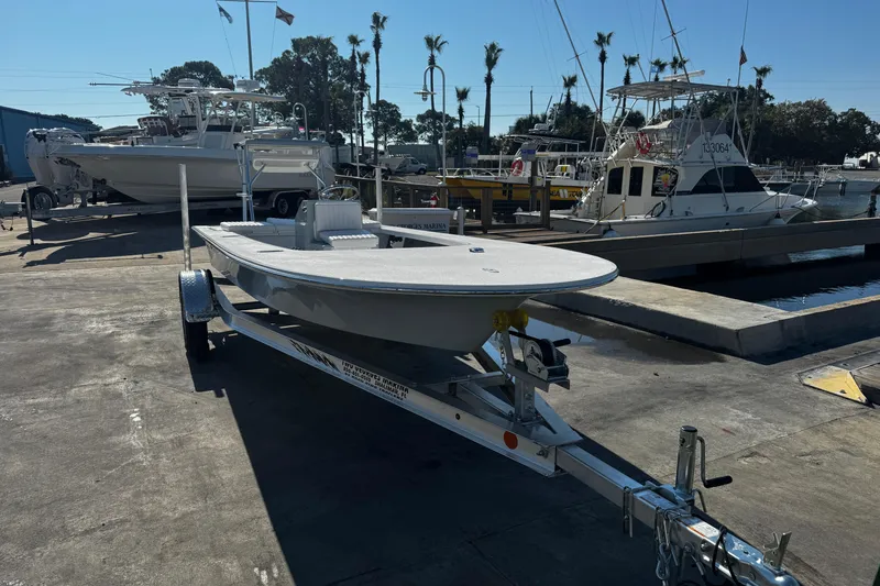 Slide: The Image of 2026 Mitzi Skiffs 17 Tournament boat on trailer at marina dockside. - 4