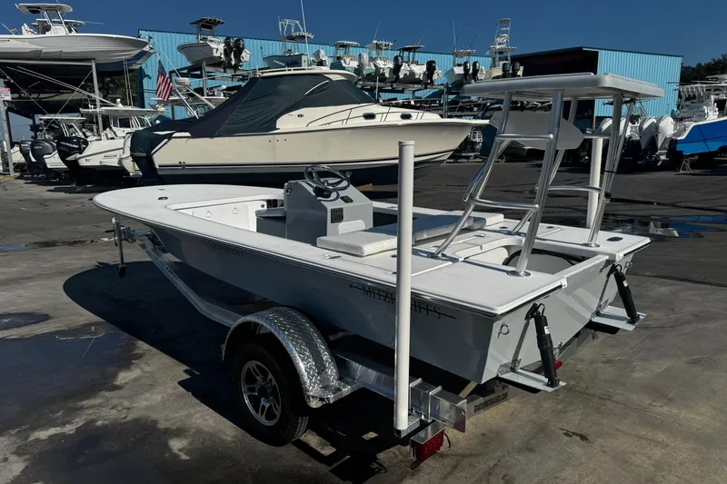 Slide: The Image of 2026 Mitzi Skiffs 17 Tournament boat on trailer in marina setting. - 8