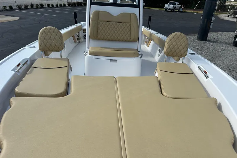 Slide: The Image of 2025 Sportsman Masters 267 Bay Boat interior with beige cushioned seating. - 10