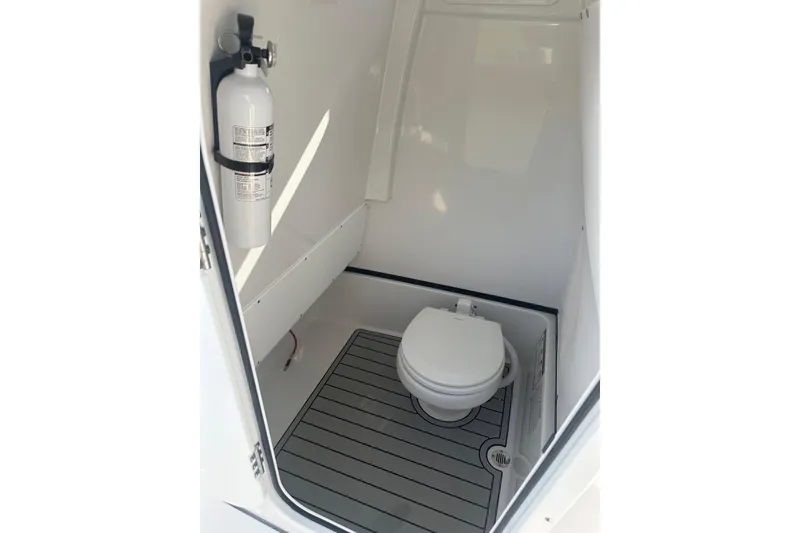Slide: The Image of 2025 Sportsman Masters 267 Bay Boat interior with toilet and fire extinguisher. - 12