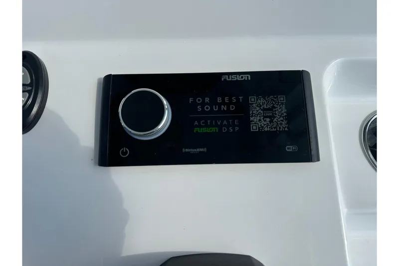 Slide: The Image of Control panel on 2025 Sportsman Masters 267 Bay Boat, featuring Fusion audio system. - 13