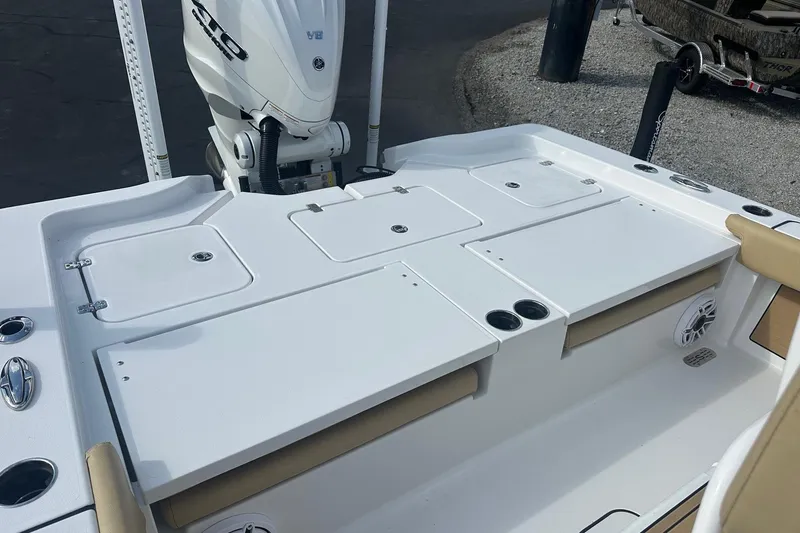 Slide: The Image of 2025 Sportsman Masters 267 Bay Boat deck with storage compartments and motor. - 14