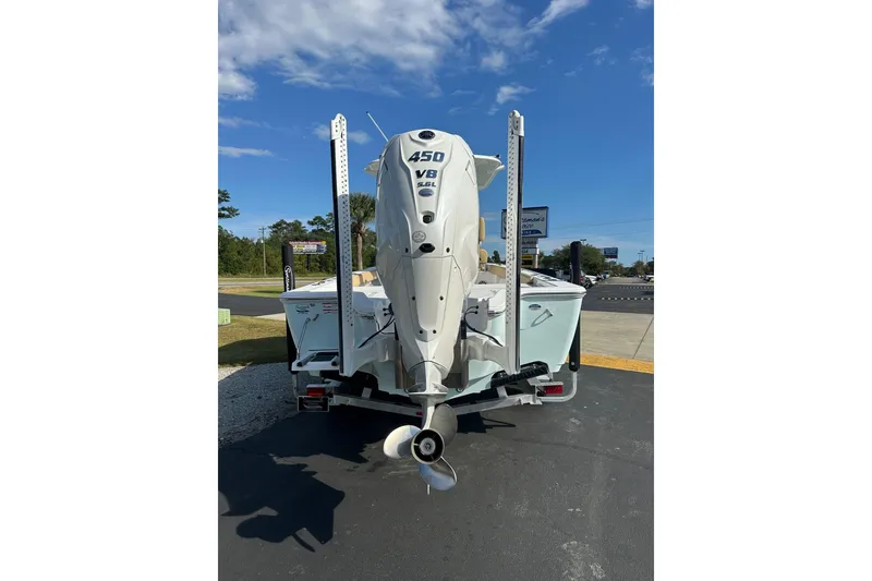 Slide: The Image of 2025 Sportsman Masters 267 Bay Boat with powerful 450 HP engine, parked outdoors. - 17