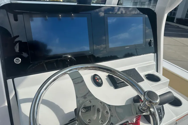 Slide: The Image of Steering console of 2025 Sportsman Masters 267 Bay Boat with dual Garmin displays. - 3
