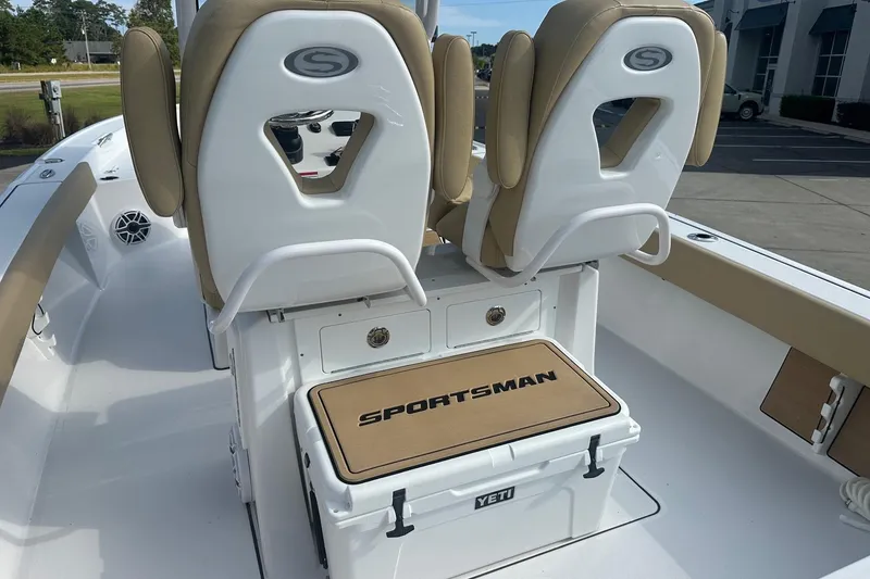 Slide: The Image of 2025 Sportsman Masters 267 Bay Boat interior with cushioned seats and Yeti cooler. - 5