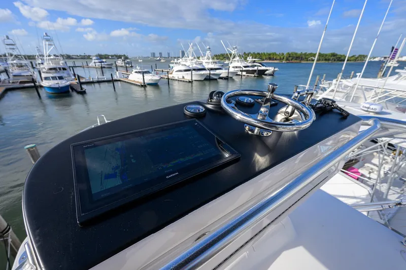 Slide: The Image of 2015 Viking 52 Open yacht helm with navigation display, docked at marina. - 19