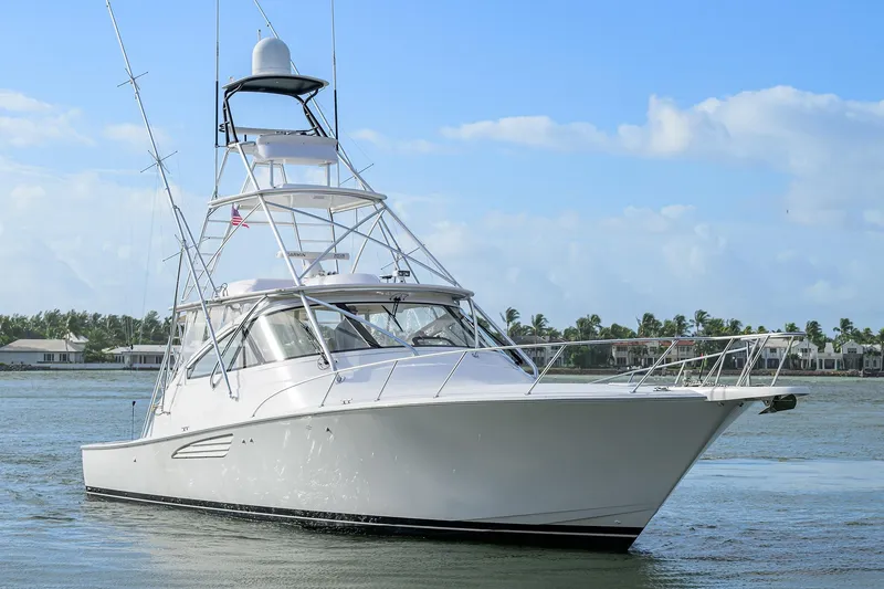 Slide: The Image of 2015 Viking 52 Open yacht cruising on calm waters under a clear blue sky. - 2