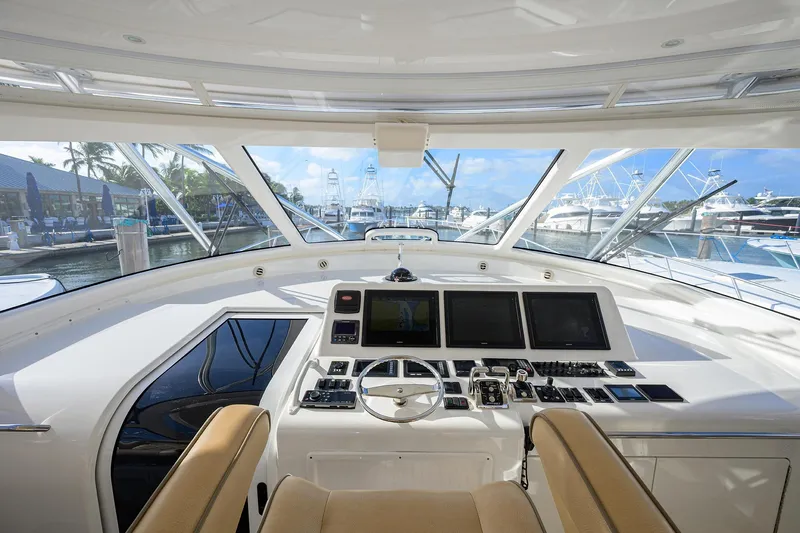 Slide: The Image of Interior view of 2015 Viking 52 Open yacht helm with modern controls and marina backdrop. - 32