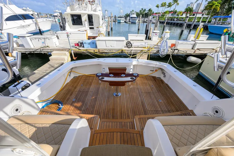 Slide: The Image of 2015 Viking 52 Open yacht with teak deck at marina, surrounded by boats. - 37
