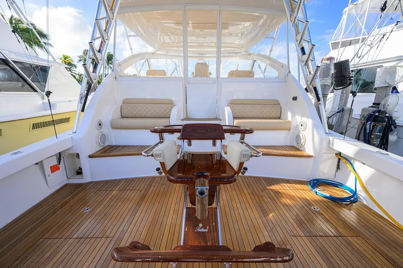 Slide: The Image of 2015 Viking 52 Open yacht interior with teak flooring and cushioned seating. - 39