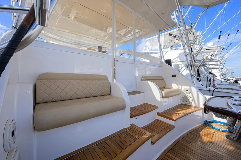Slide: The Image of 2015 Viking 52 Open yacht interior with cushioned seating and wooden steps. - 42