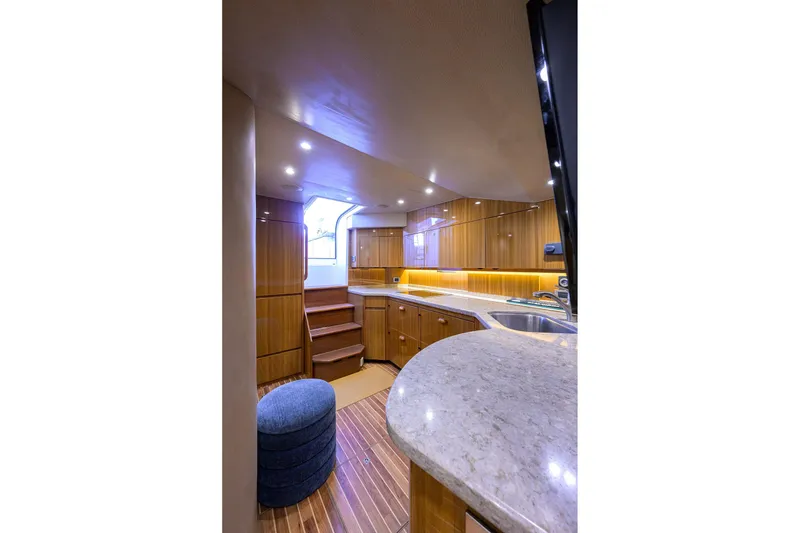 Slide: The Image of Luxurious interior of 2015 Viking 52 Open yacht with modern kitchen and wooden cabinetry. - 45