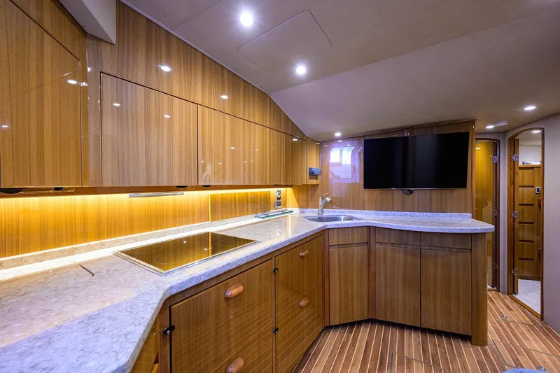 Slide: The Image of Luxurious interior of 2015 Viking 52 Open yacht with modern kitchen and sleek wood finishes. - 48