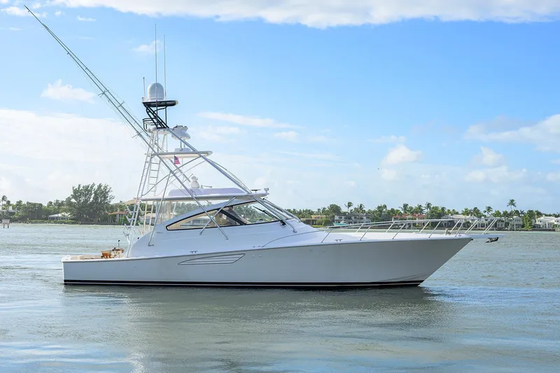 Slide: The Image of 2015 Viking 52 Open yacht on calm water under blue sky. - 5