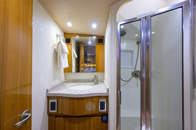 Slide: The Image of 2015 Viking 52 Open yacht bathroom with modern shower and vanity. - 54