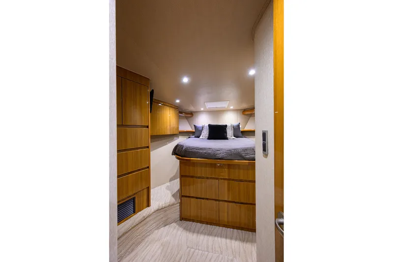Slide: The Image of Luxurious cabin interior of 2015 Viking 52 Open yacht with cozy bed and wooden cabinetry. - 57