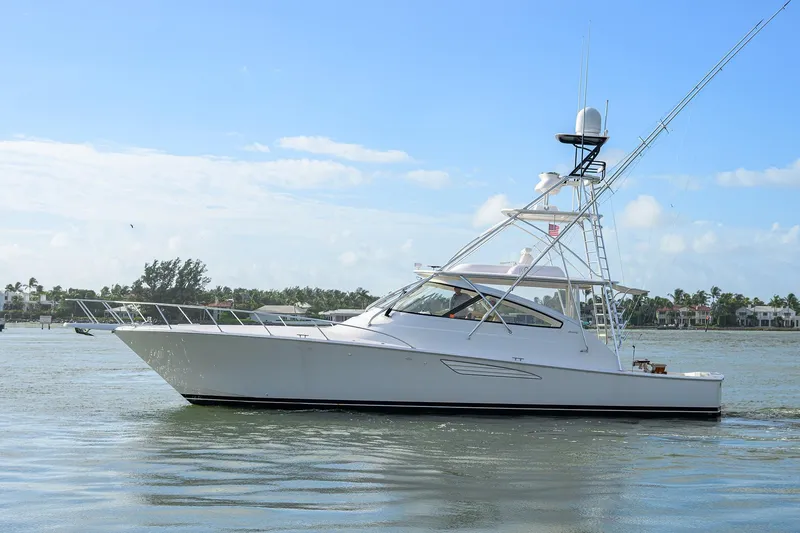 Slide: The Image of 2015 Viking 52 Open yacht cruising on calm waters under a clear blue sky. - 6