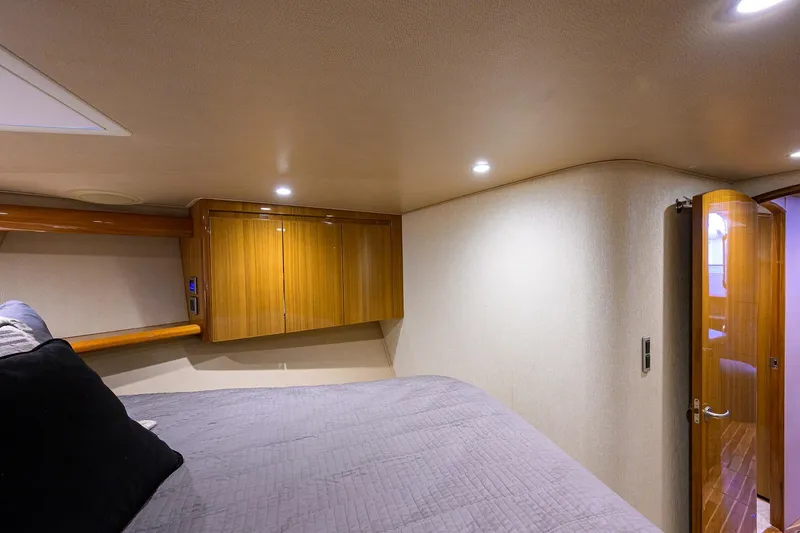 Slide: The Image of Luxurious cabin interior of 2015 Viking 52 Open yacht with wooden cabinetry and cozy bedding. - 60