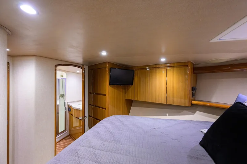 Slide: The Image of Luxurious 2015 Viking 52 Open yacht cabin with wood cabinetry and modern amenities. - 61