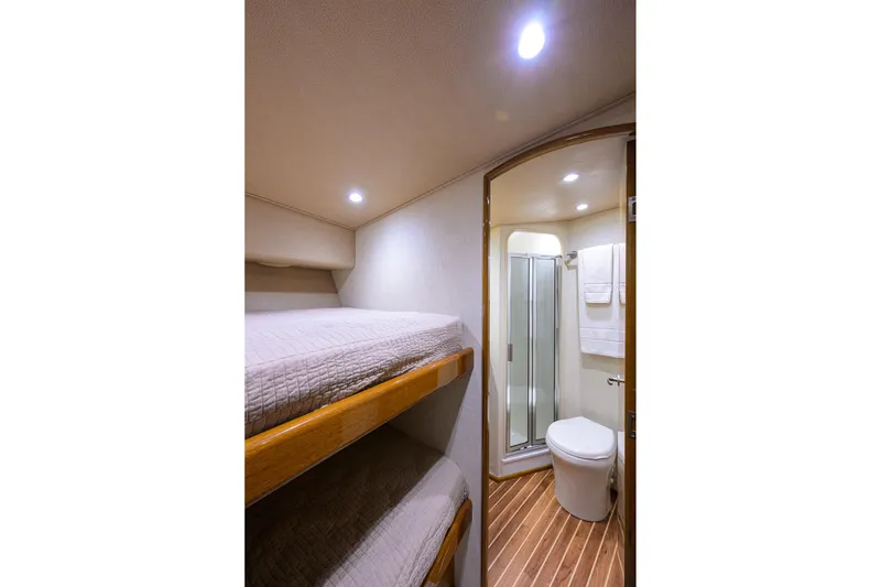 Slide: The Image of 2015 Viking 52 Open yacht interior with bunk beds and bathroom. - 68