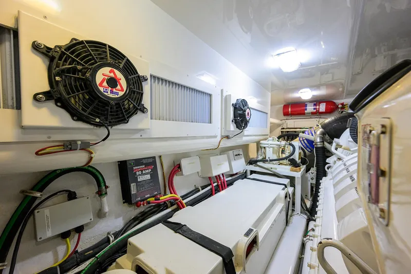 Slide: The Image of Engine room of 2015 Viking 52 Open yacht, featuring fans and wiring. - 72