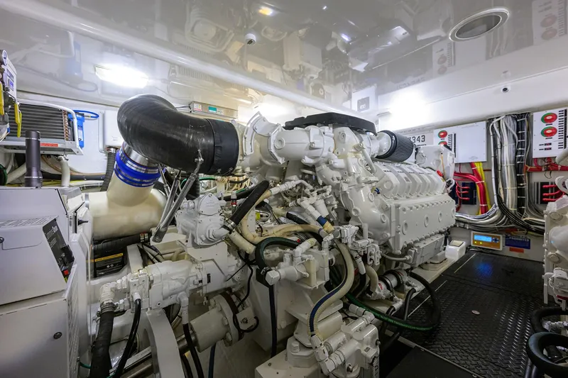 Slide: The Image of Engine room of a 2015 Viking 52 Open yacht, showcasing complex machinery and wiring. - 75