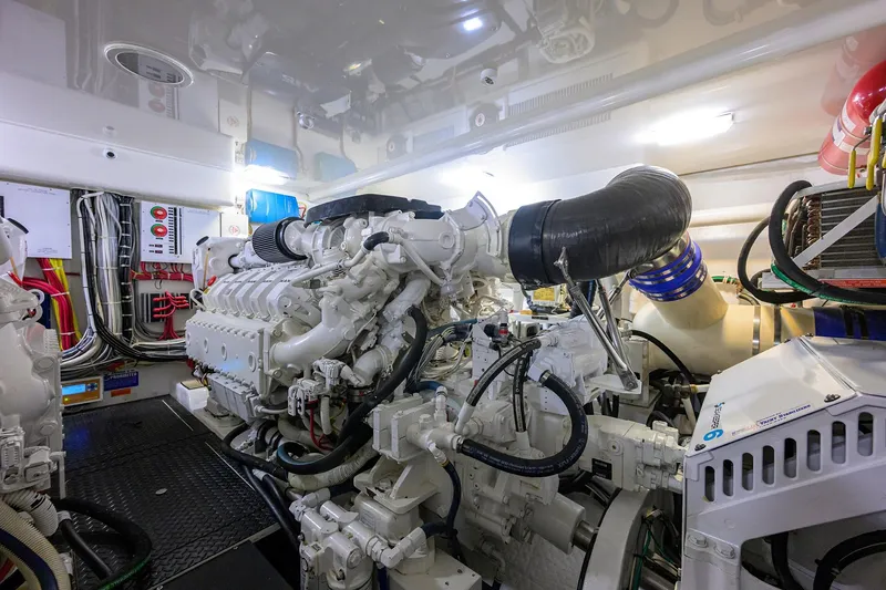 Slide: The Image of Engine room of 2015 Viking 52 Open yacht, showcasing complex machinery and wiring. - 76