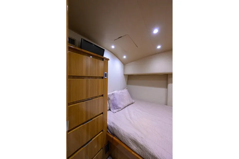 Slide: The Image of Cozy bedroom interior of 2015 Viking 52 Open yacht with wooden cabinetry. - 82