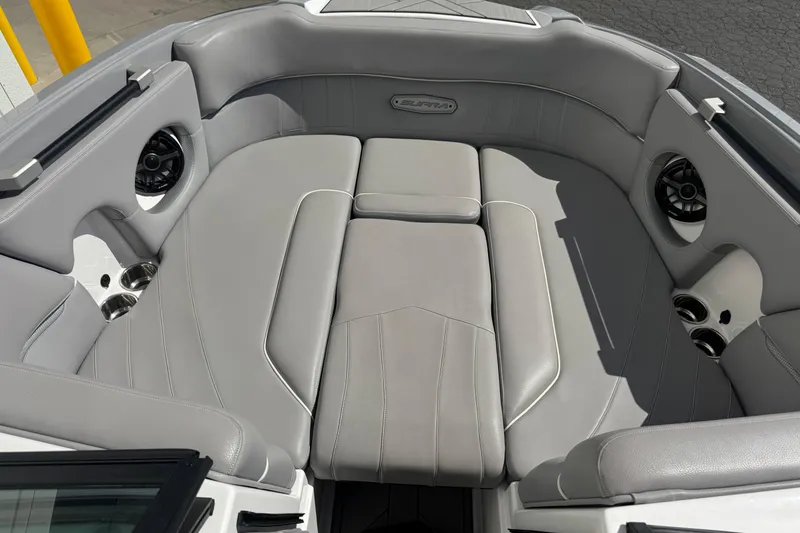 Slide: The Image of 2019 Supra SE 575 boat interior with gray leather seating and built-in speakers. - 6
