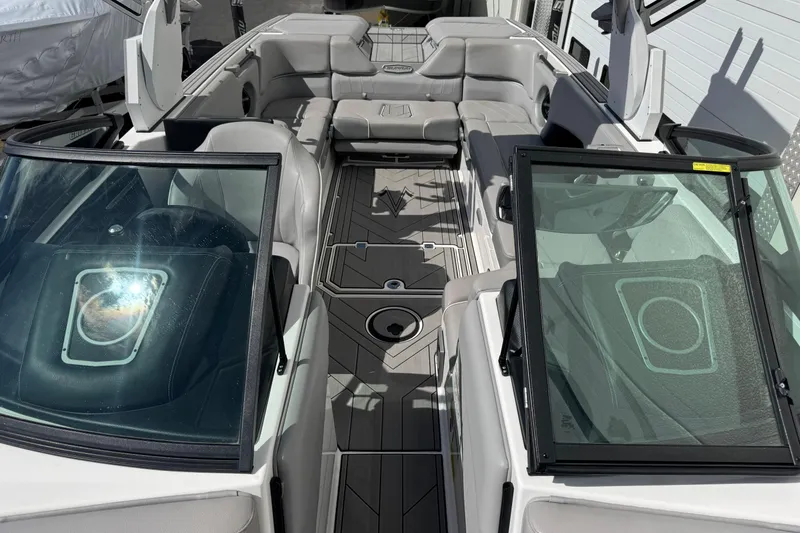 Slide: The Image of 2019 Supra SE 575 boat interior with gray seating and sleek design. - 7