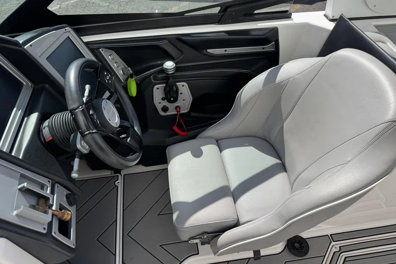 Slide: The Image of 2019 Supra SE 575 boat cockpit with steering wheel and comfortable seat. - 9