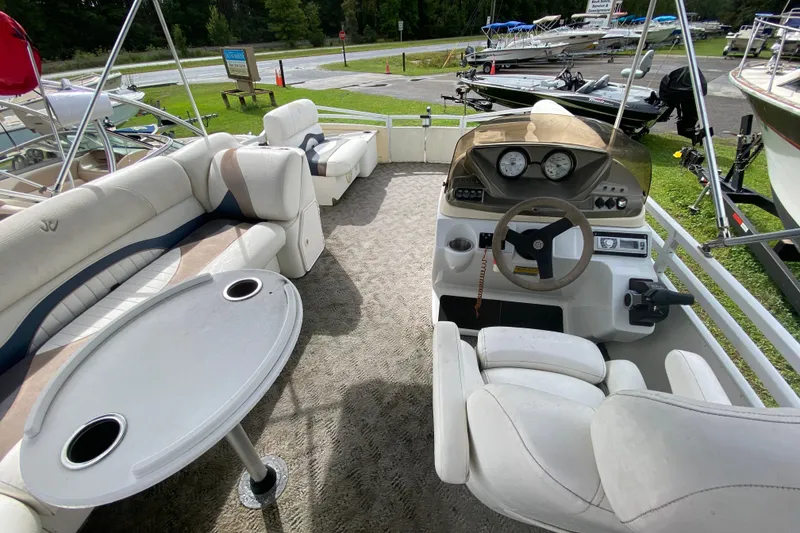 Slide: The Image of Pontoon boat interior with seating, table, and steering console, JC NEPTOON 19, 2010 model. - 10