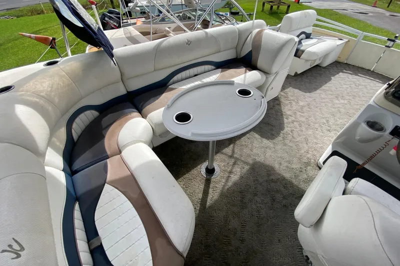 Slide: The Image of Luxurious seating area on a 2010 JC NEPTOON 19 boat with a round table. - 11